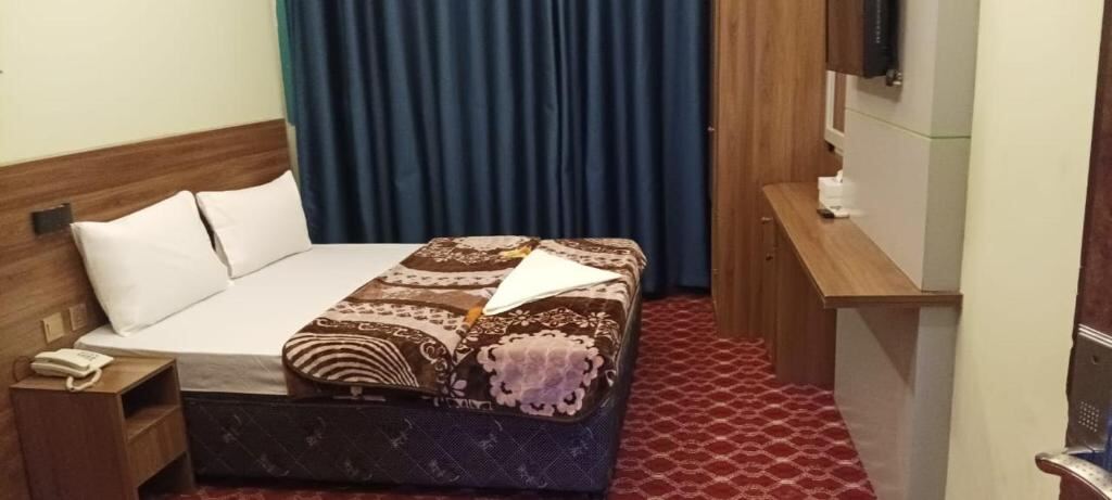 Guest room with a queen bed at Homa Hotel, Deira, Dubai